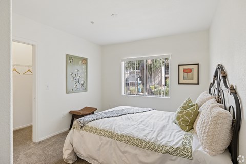 A bedroom with a large bed and a window.