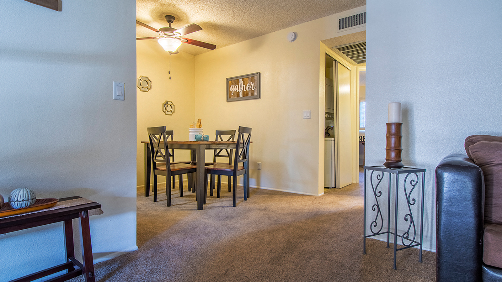 our living room and dining room with a table and chairs and a ceiling fan