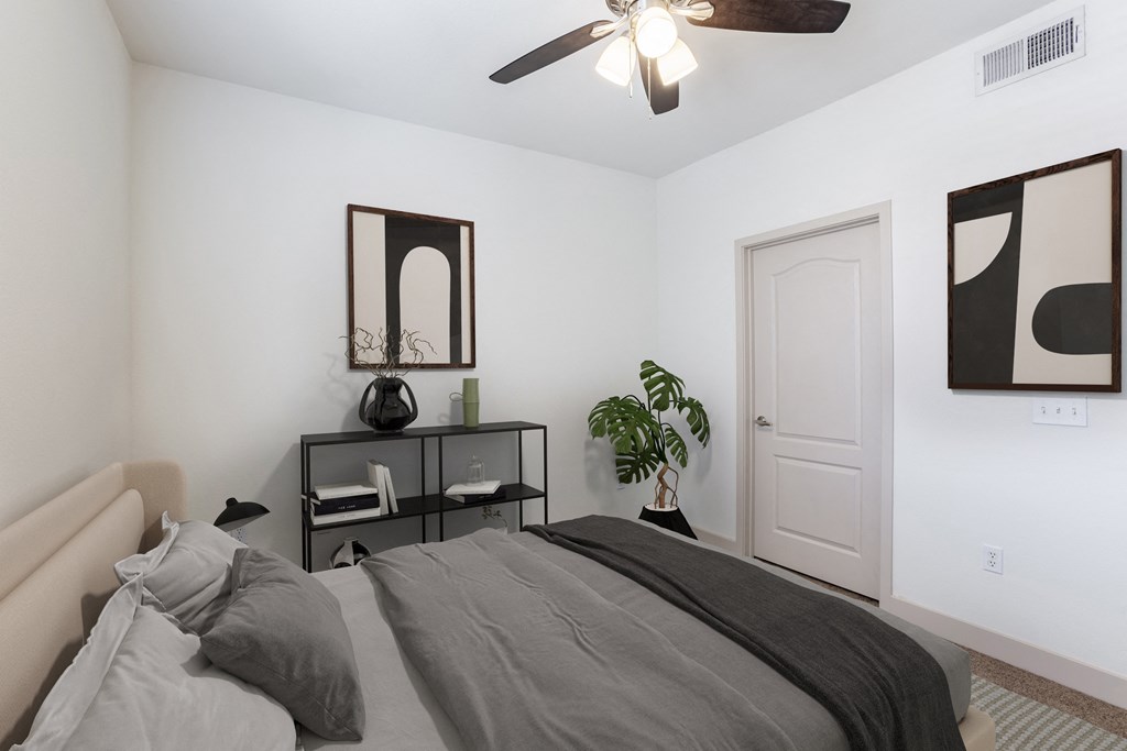 a bedroom with a large bed and a ceiling fan