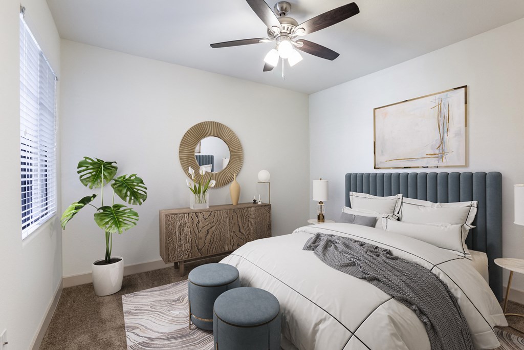 a bedroom with a large bed and a ceiling fan