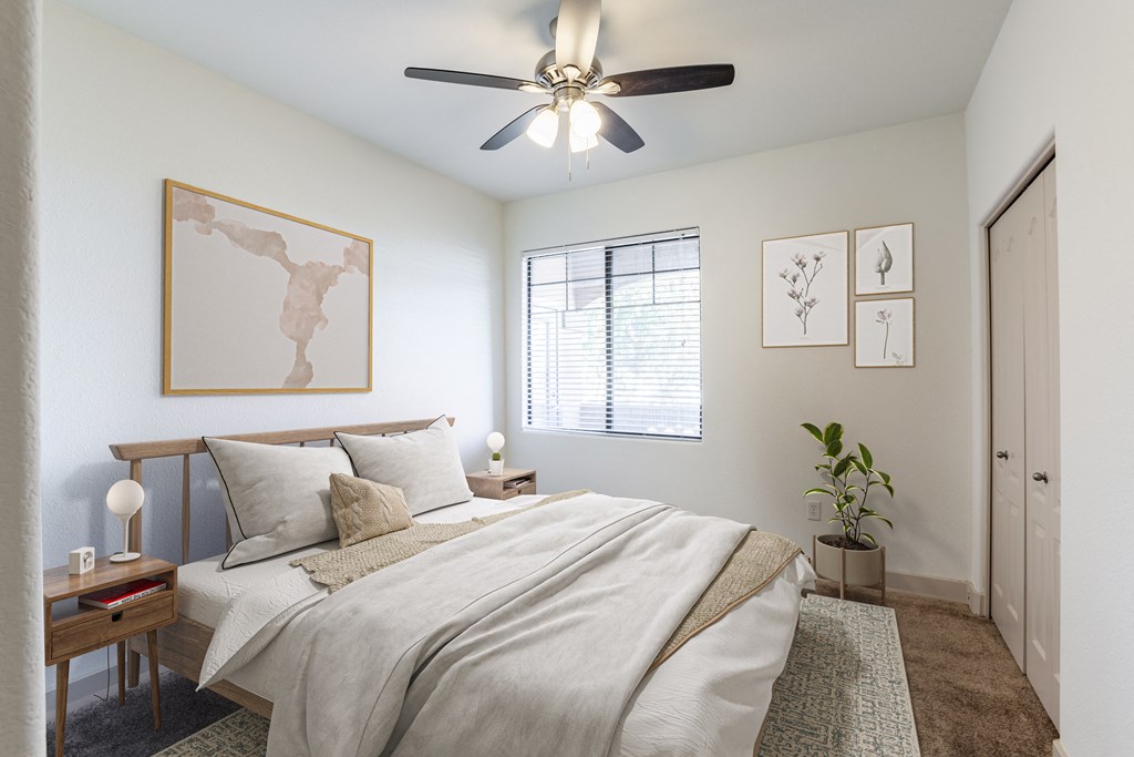 a bedroom with a ceiling fan and a window