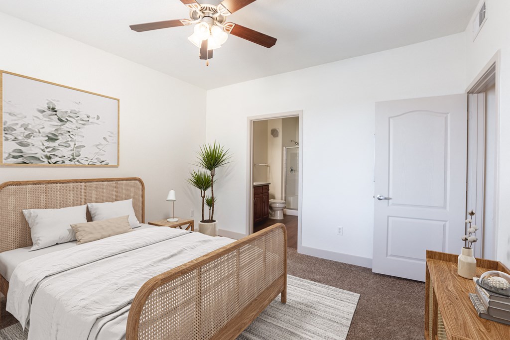 a bedroom with a bed and a ceiling fan