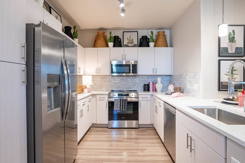 a kitchen with stainless steel appliances and white cabinets