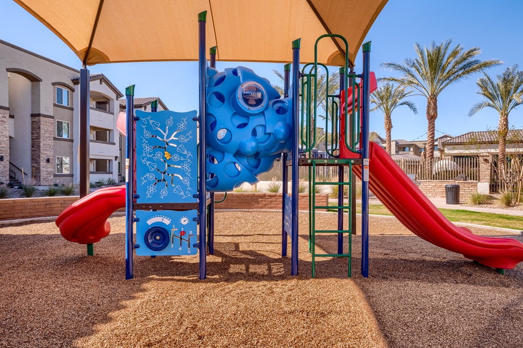 a playground with a slide and climbing equipment in a park