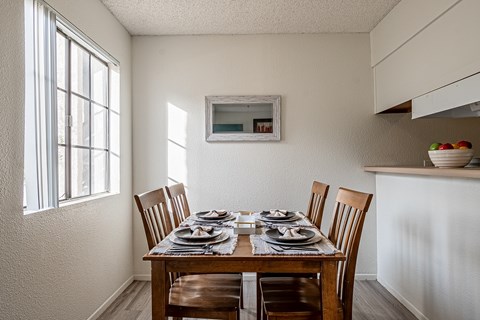 A dining room with a table set for two.