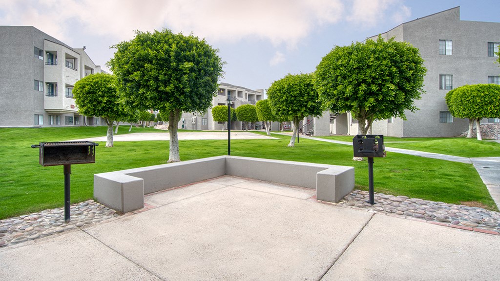 El Encanto outside view of courtyard with lush landscape and BBQ area