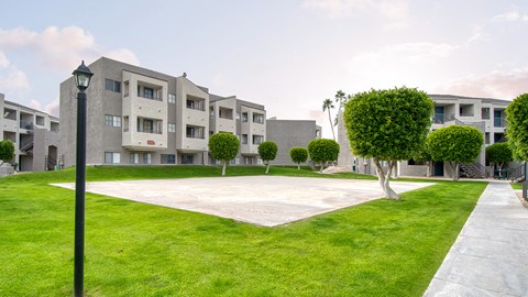 El Encanto sports court with lush landscape surounding