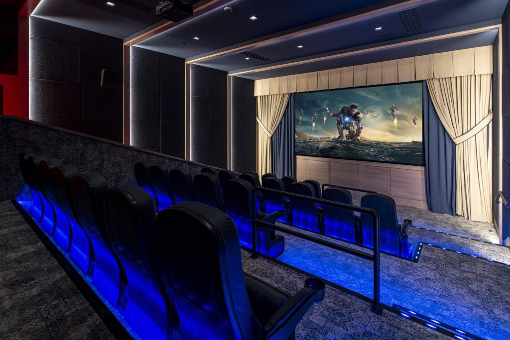 a cinema room with chairs and a large screen