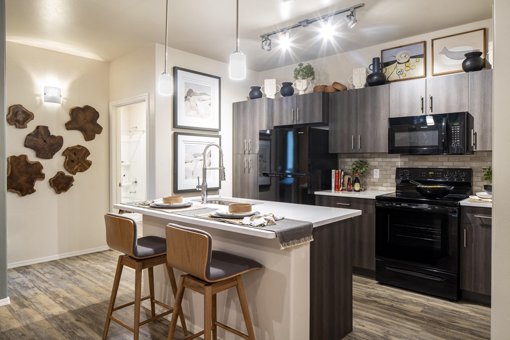 a kitchen with a large center island with two stools