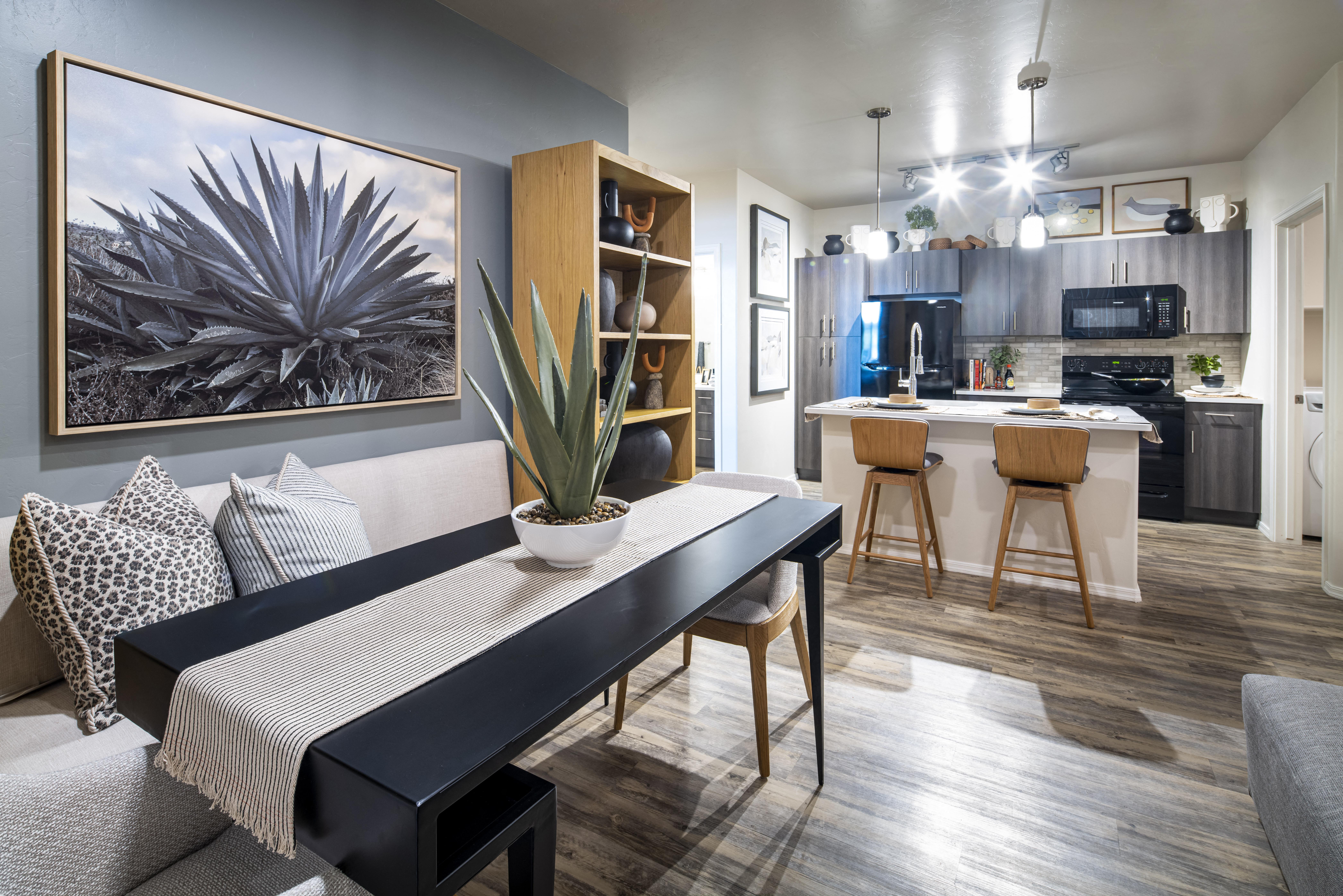 a living room with a dining room table and a kitchen