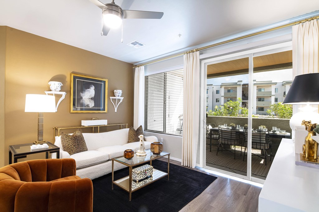 a living room with a large window and a couch and a table