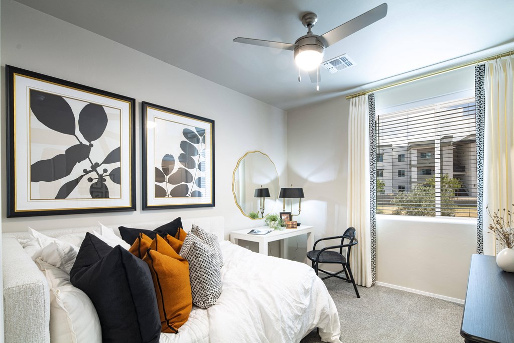 a bedroom with a large bed and a ceiling fan