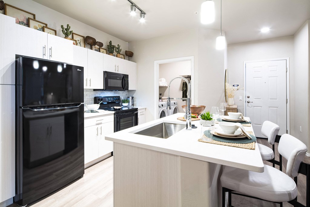 a kitchen with black appliances and a white counter top