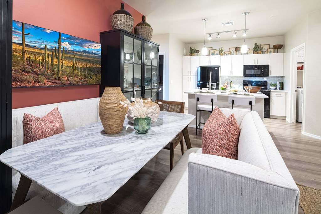 a living room with a dining room table and a kitchen