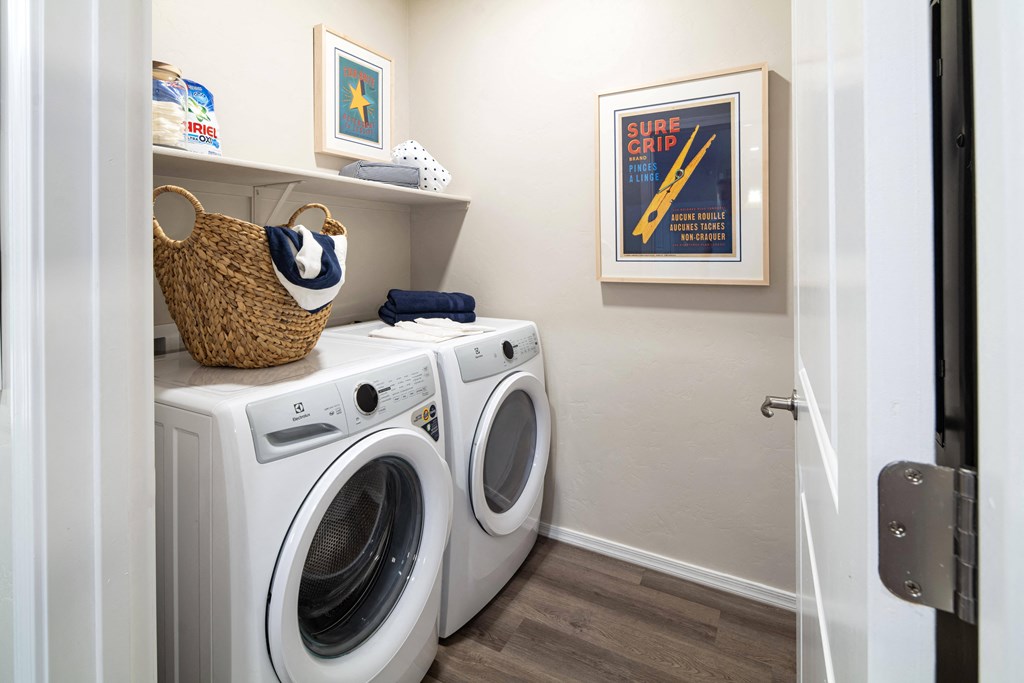 a washer and dryer in a laundry room with a white door