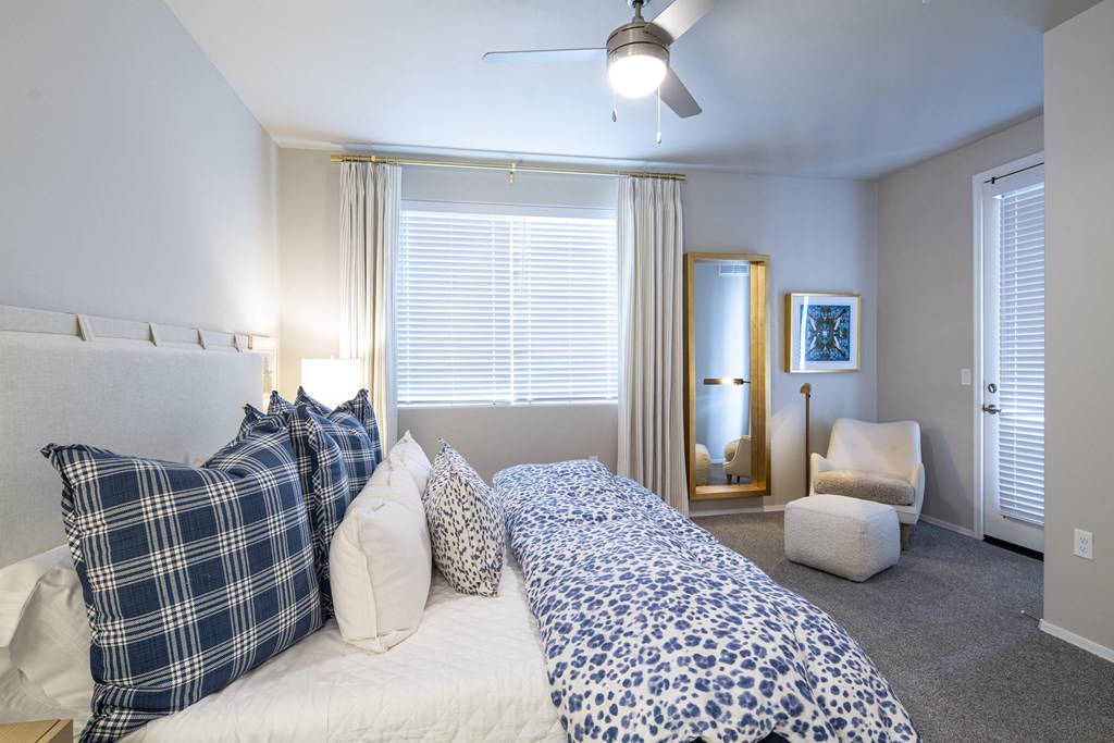 a bedroom with a large bed and a ceiling fan