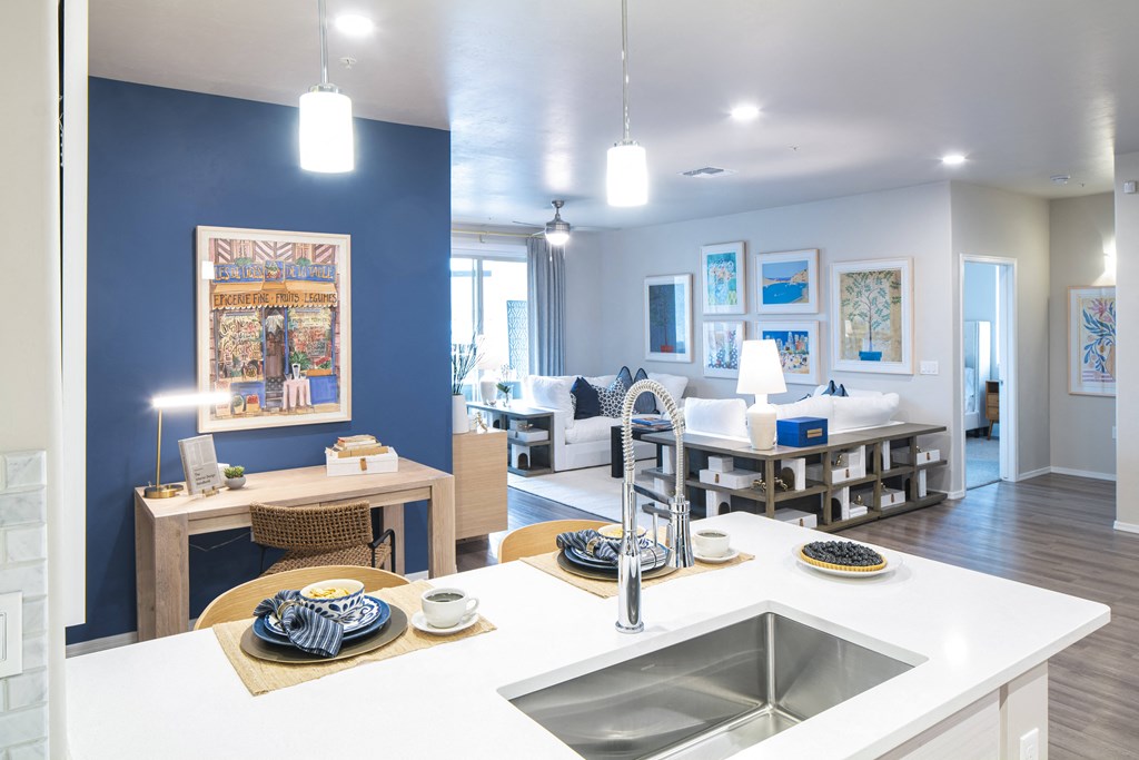 a kitchen and living room with blue walls and white counter tops