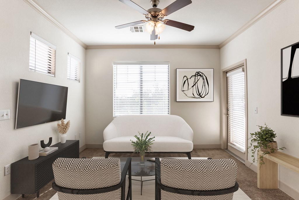 a living room with a ceiling fan and a television on the wall