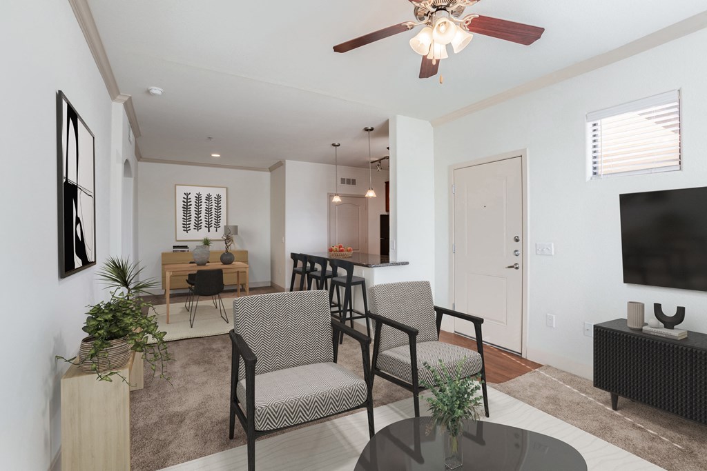 a living room with a ceiling fan and a table with chairs