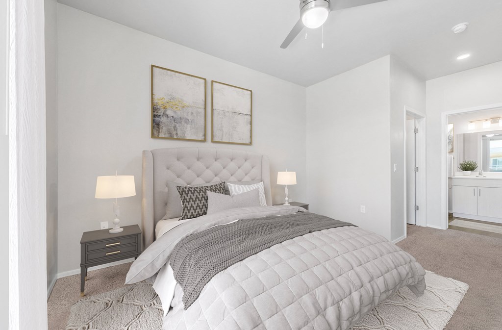 a bedroom with a large bed and two night stands with lamps