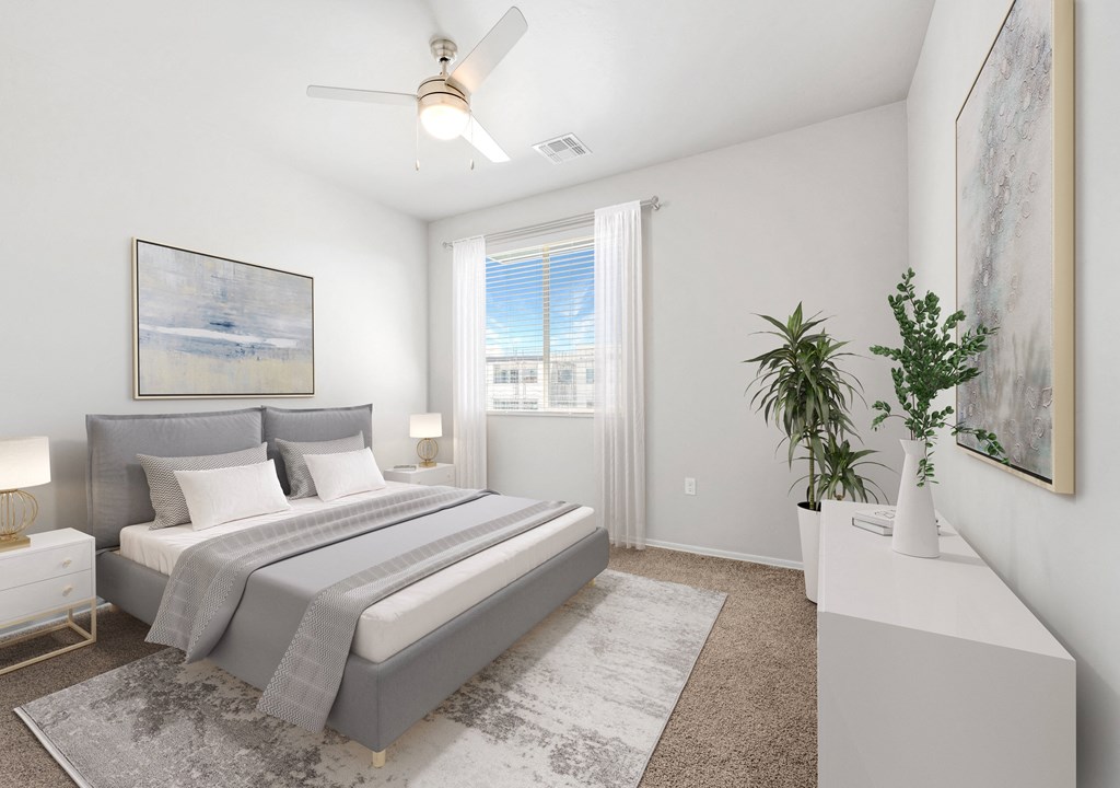 a bedroom with a large bed and a ceiling fan