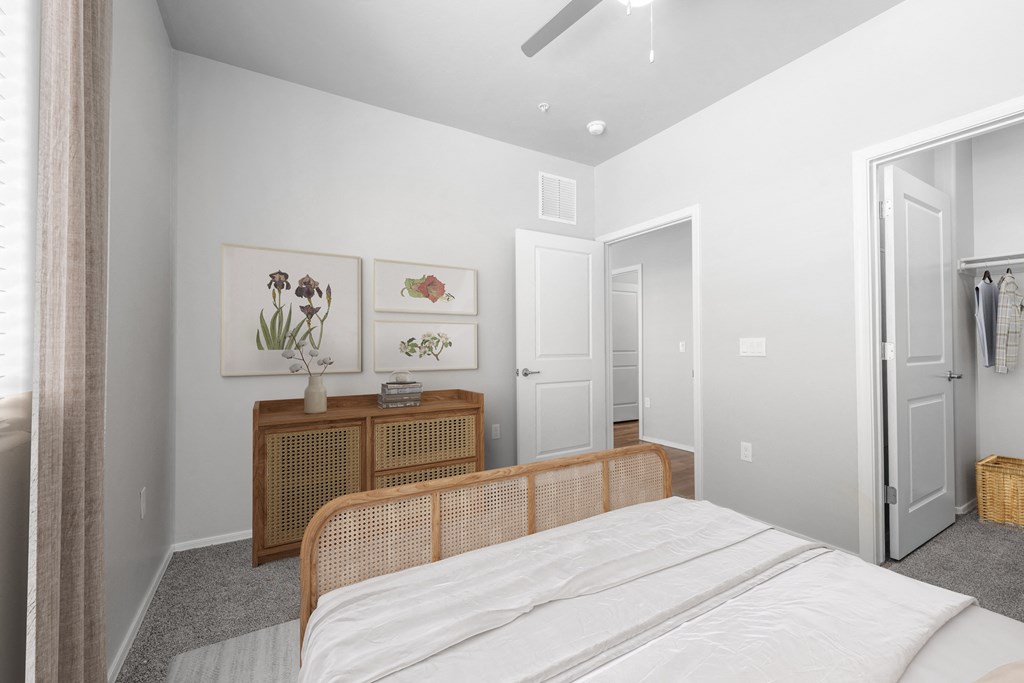 a bedroom with white walls and gray carpet