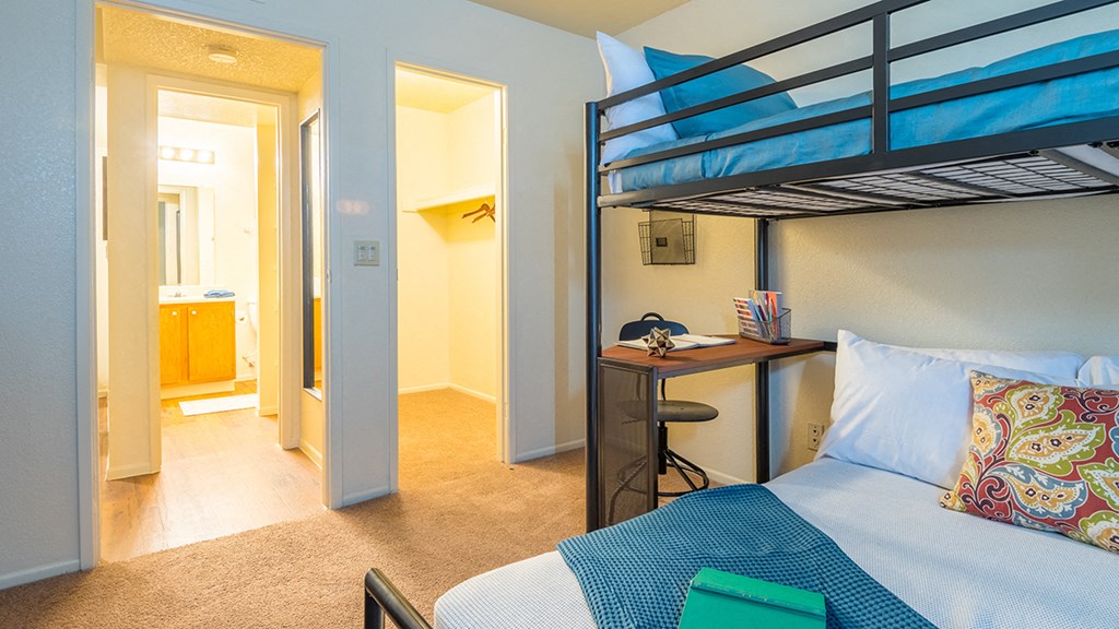 Enclave spacious bedroom with bed and bunk bed