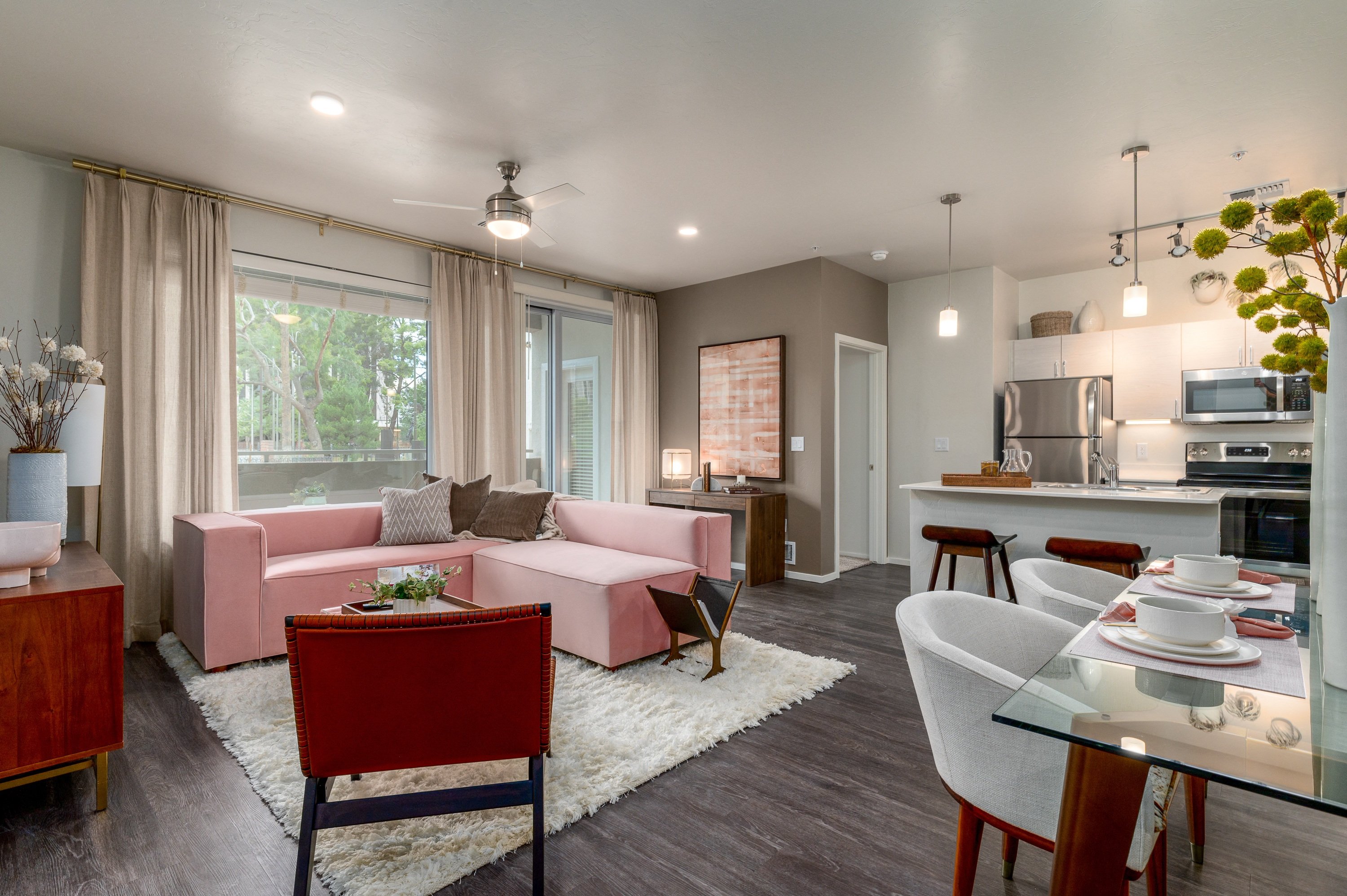 a living room with a pink couch and a table