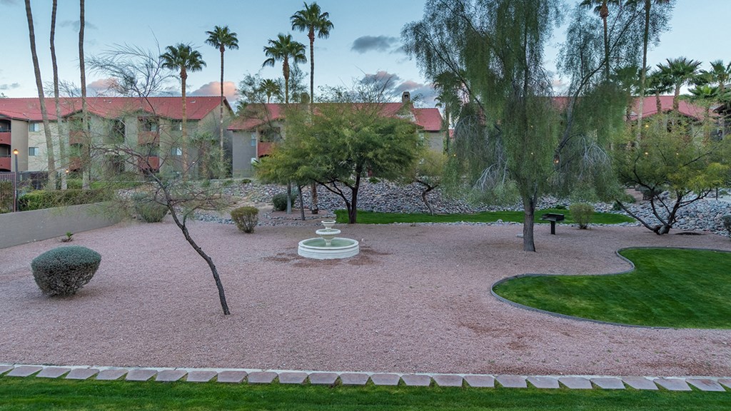 Enclave outside view with lush landscape, and fountain