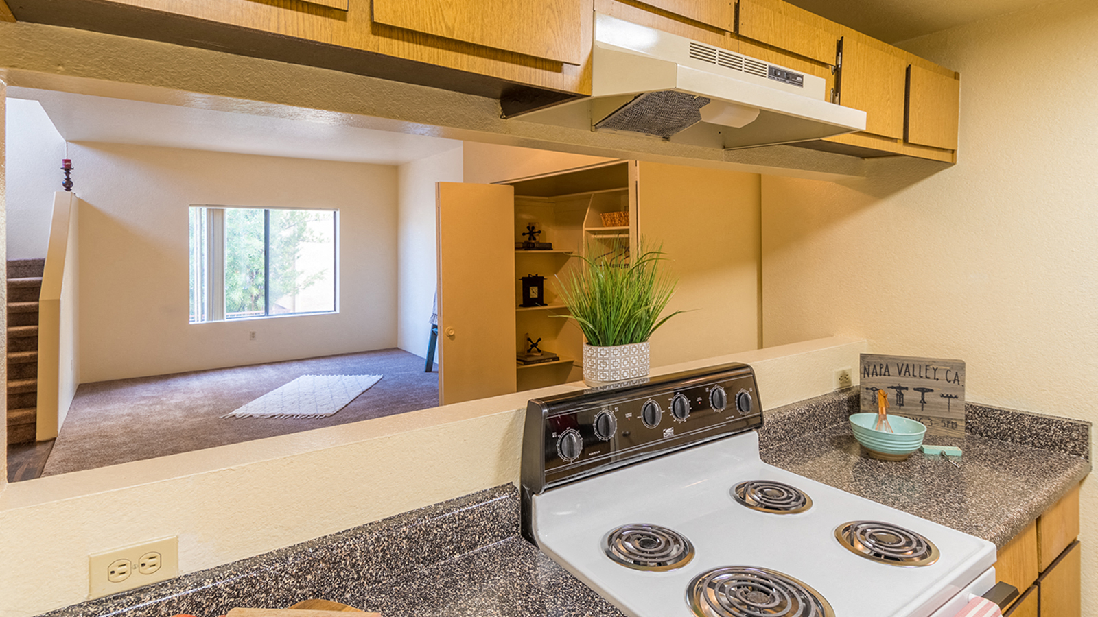 Kitchen view of living room with white stove top