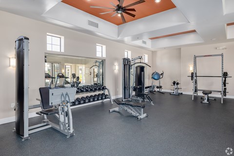 A spacious home gym with a variety of exercise equipment.