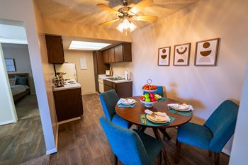 A dining room with a table set for four.
