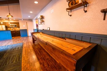 A long wooden table is in the middle of a room.