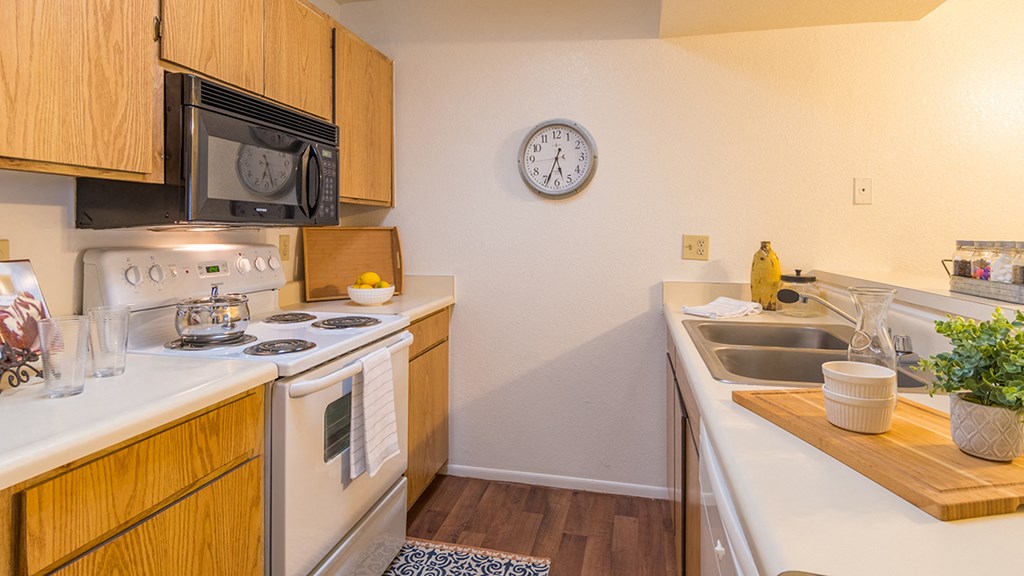 Ridgepointe spacious kitchen with wood flooring and plenty of cabinetry