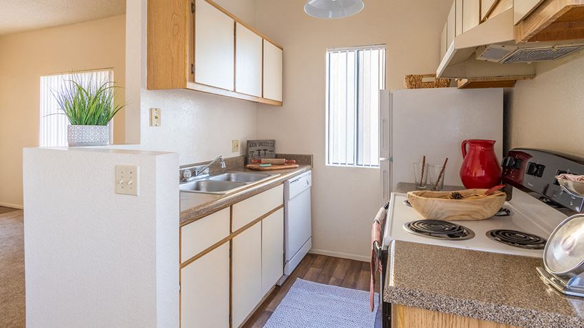 Brittany Court kitchen with fridge, stove, and plenty of cabinetry - Photo Gallery