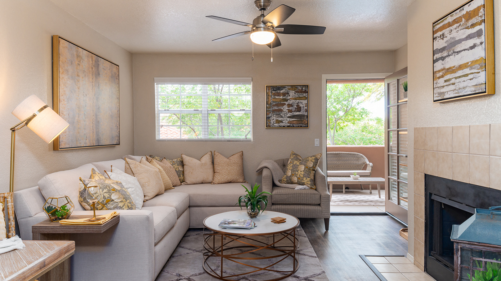 a living room with a couch and a ceiling fan