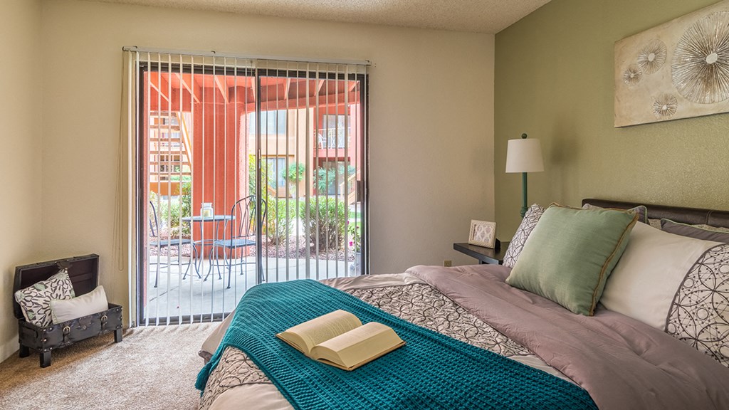 Ridgepointe large bedroom with glass doors and access to patios and balconies