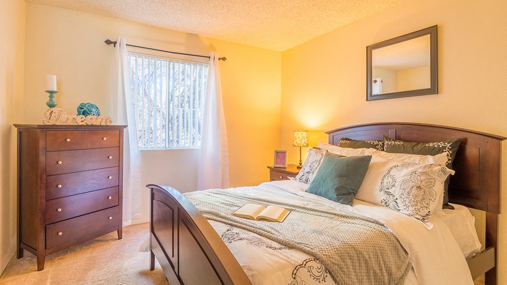 The Springs bedroom with carpet flooring and nice lighting