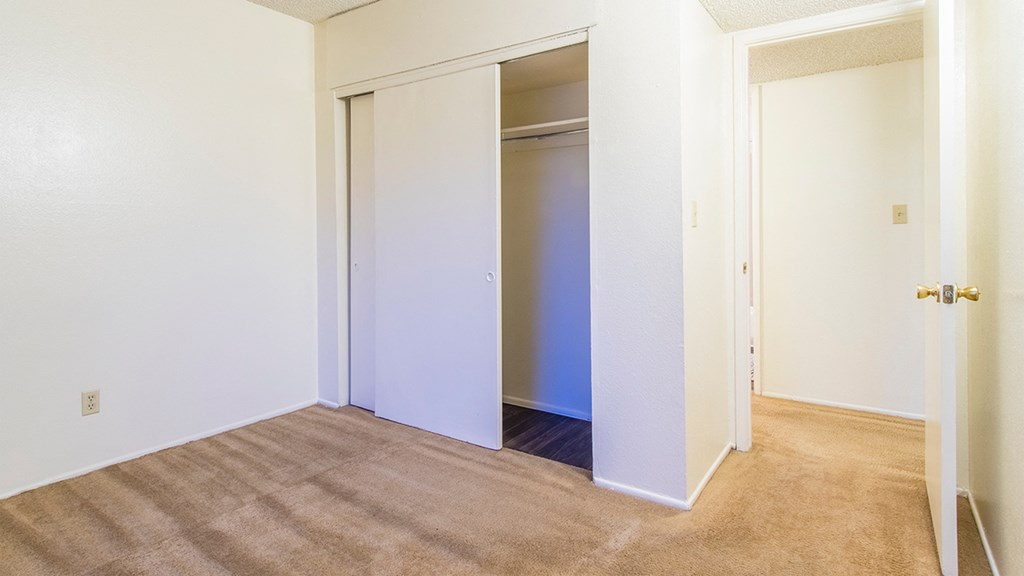 tanglewood bedroom with large spacious closets and carpet flooring