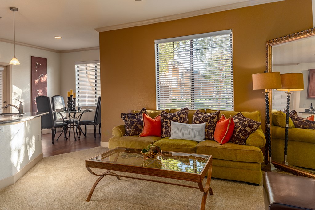 a living room filled with furniture and a large window