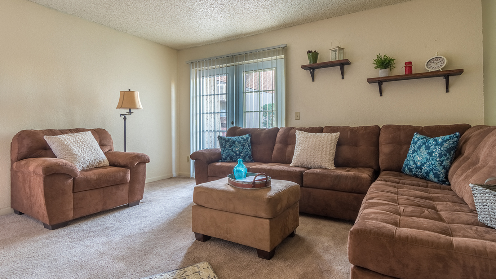 Somerpointe living room with plenty of couches and lounging space with carpet flooring