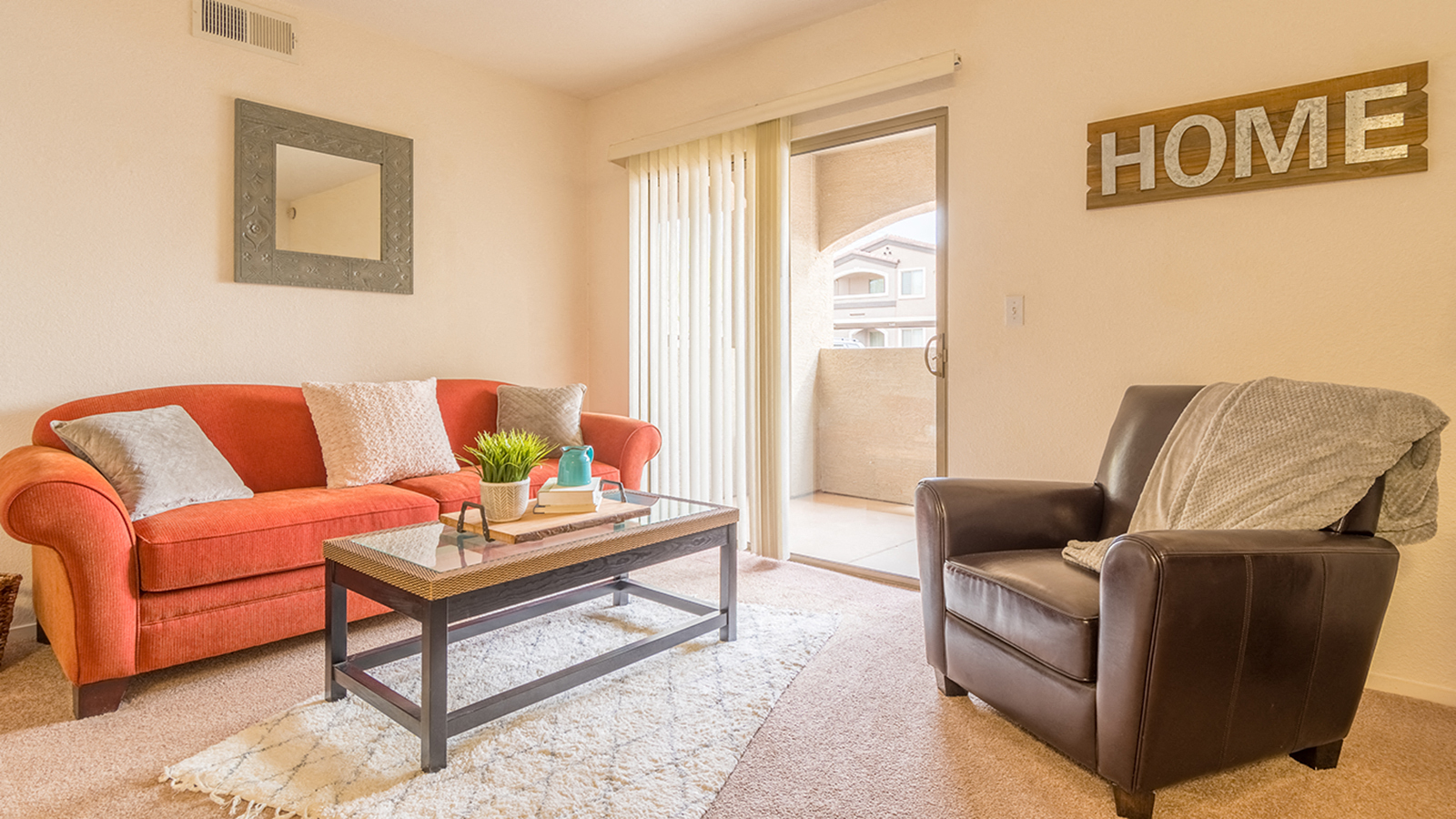 a living room with a couch and chair and a table