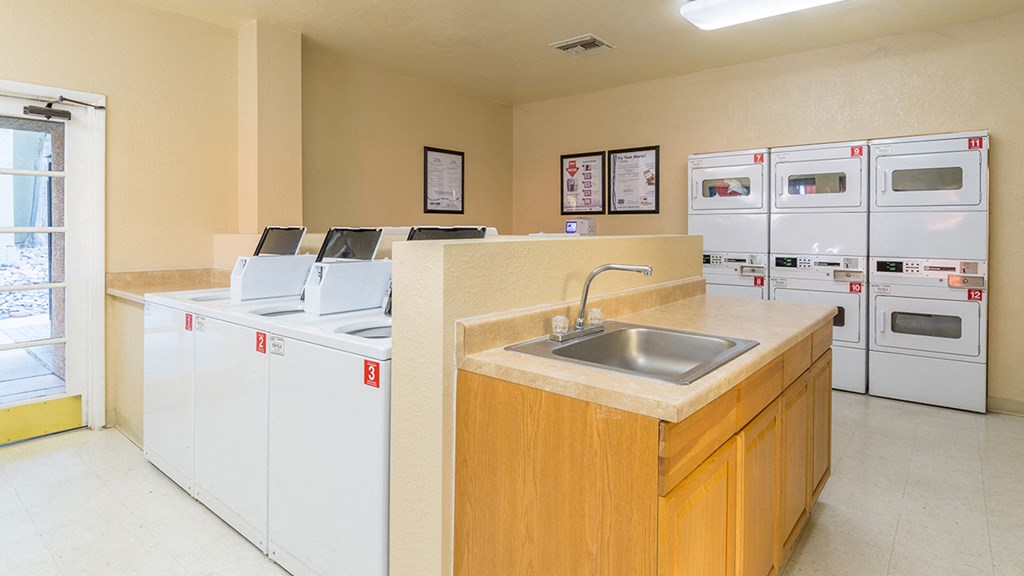 Laundry room with washers and dryers and sink