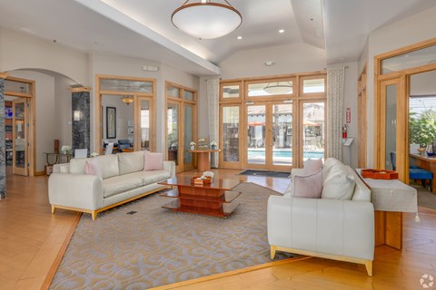 A living room with a white sofa and a wooden coffee table.