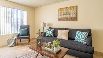 The Springs living room with nice natural lighting and carpet flooring - Photo Gallery 19