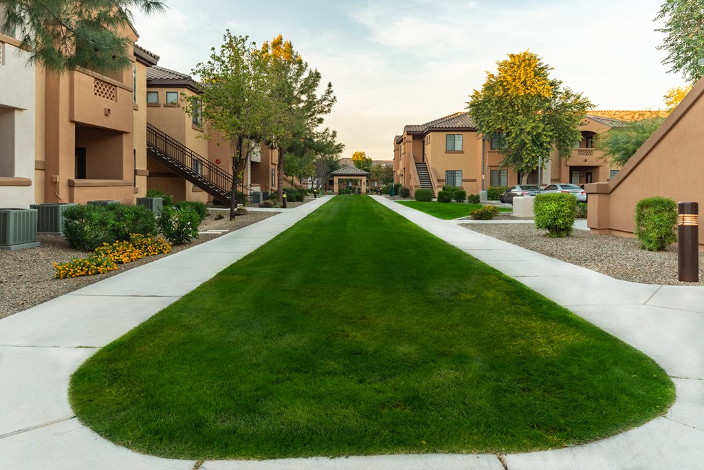 a large grassy area with houses on either side