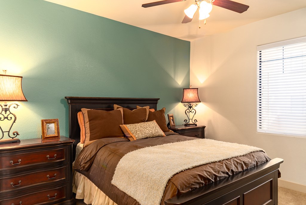 a bedroom with a bed and two night stands