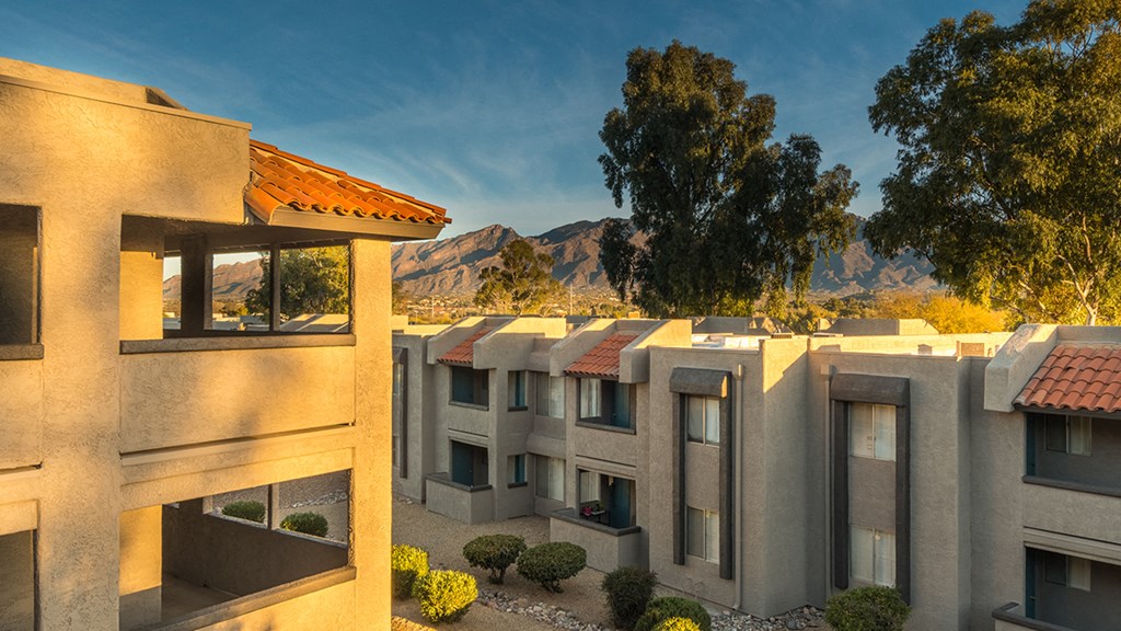 Riverstone outside view of apartments with nice tall trees surrounding