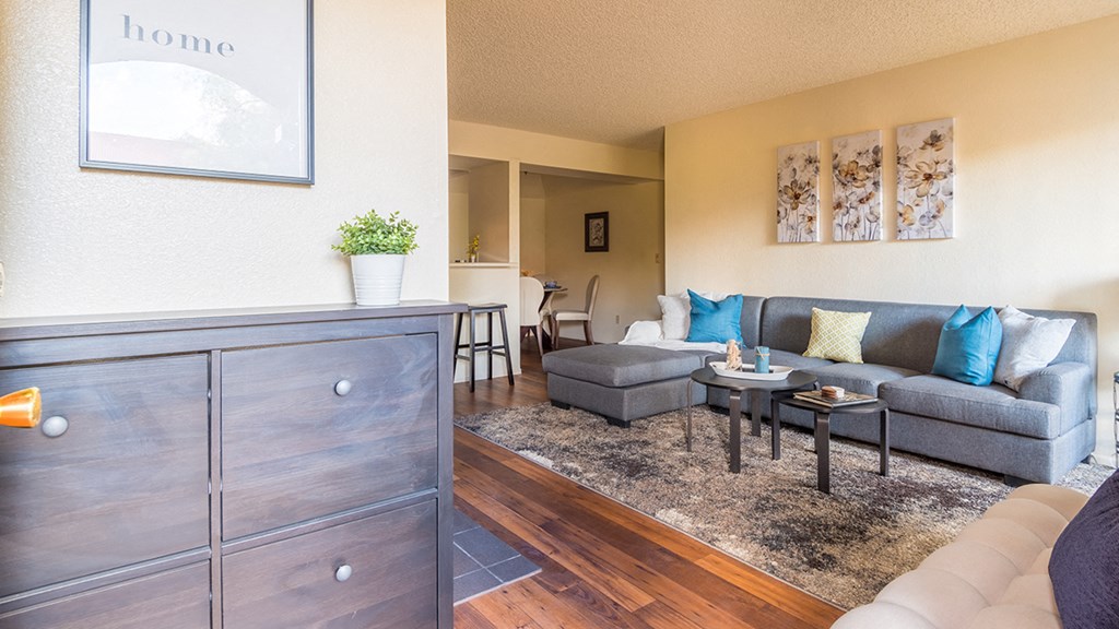 Enclave living room with cozy couches and wood-like flooring