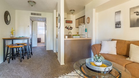El Encanto spacious living room with cozy couch and natural lighting